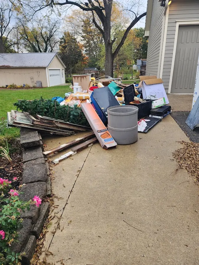Dumpster being loaded with debris for Roofing Dumpster Rental in Monroe